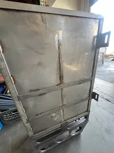 Large fabricated stainless steel frame panel with welded mounting brackets standing in the shop