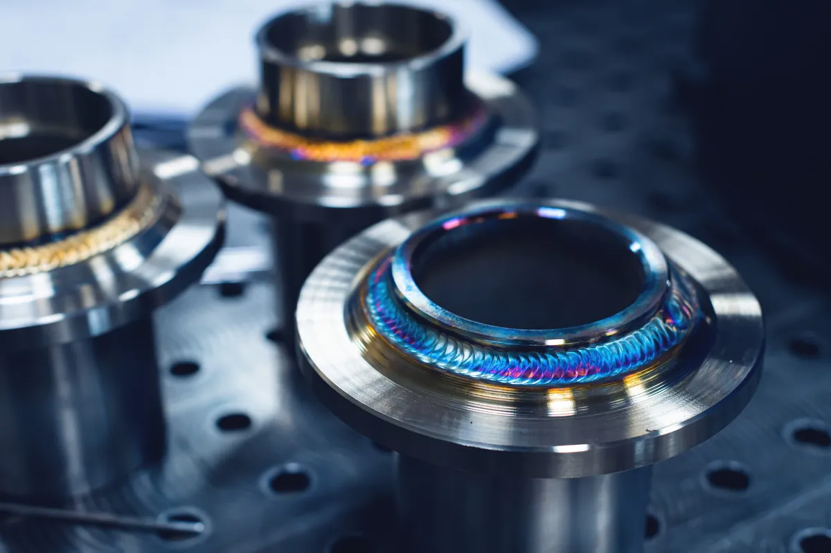 Close-up of TIG welded stainless steel flanges with heat-tinted weld beads